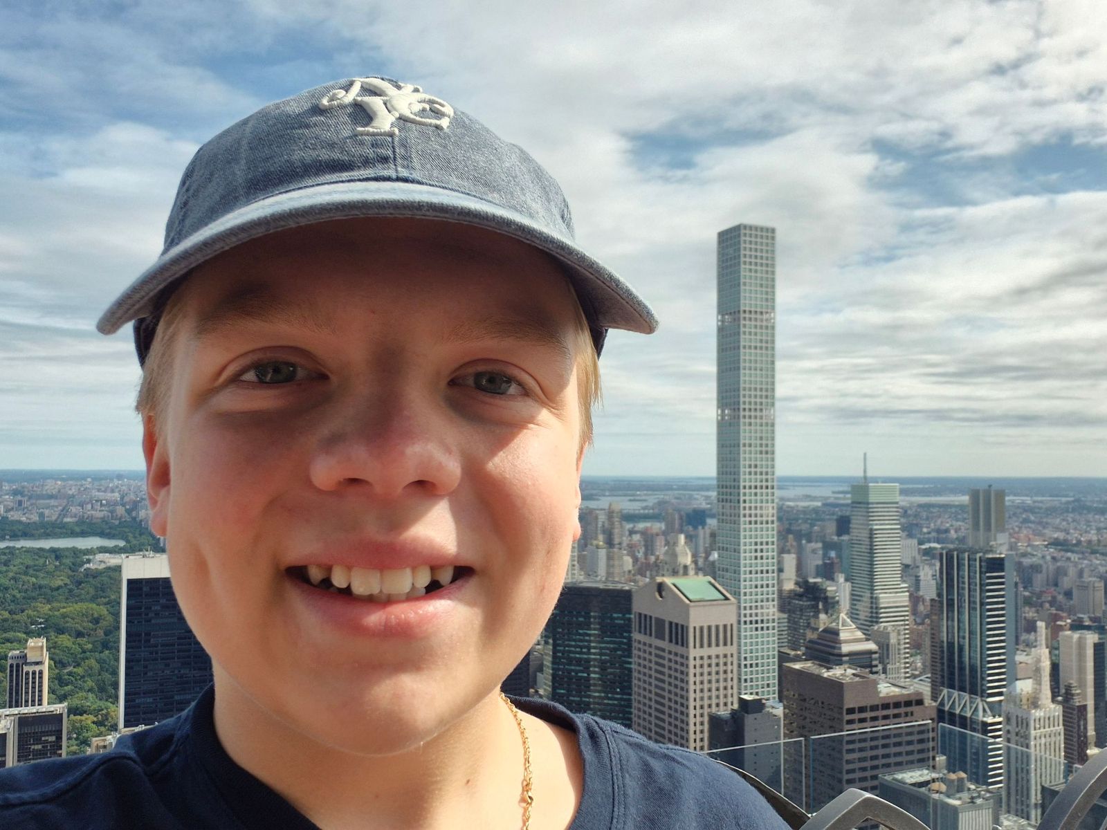 Henry in an NYC cap, high above the New York skyline with Central Park behind him